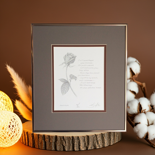 Framed artwork with a rose illustration and poem on a wooden stand against a brown background.