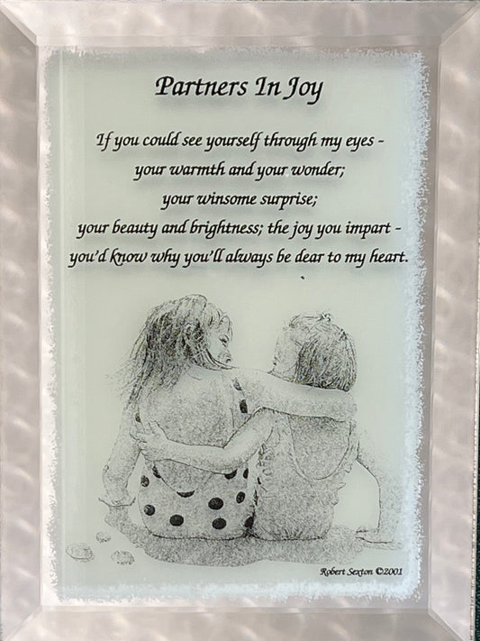 Framed artwork with a couple hugging and a romantic poem titled 'Partners In Joy'.