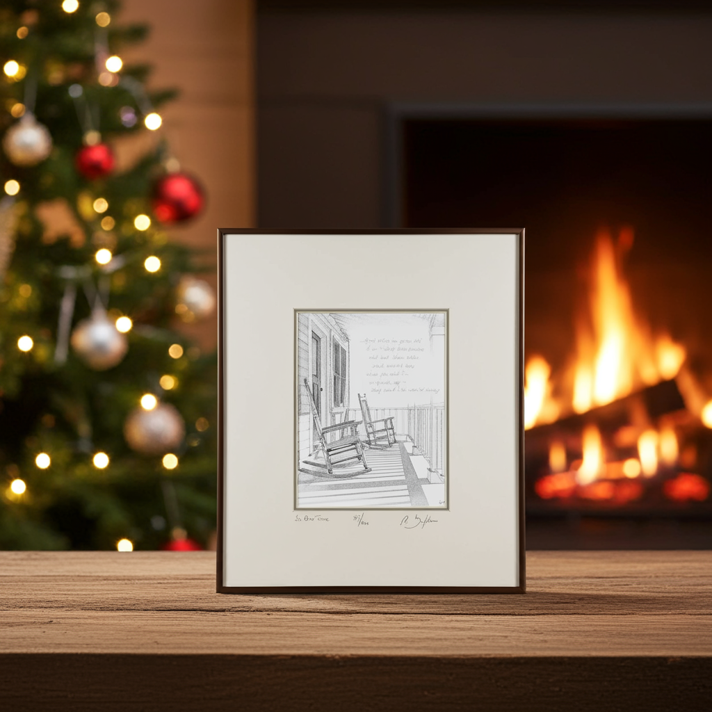 Framed black and white print of a porch scene with rocking chairs on a wooden surface with a Christmas tree and fireplace in the background
