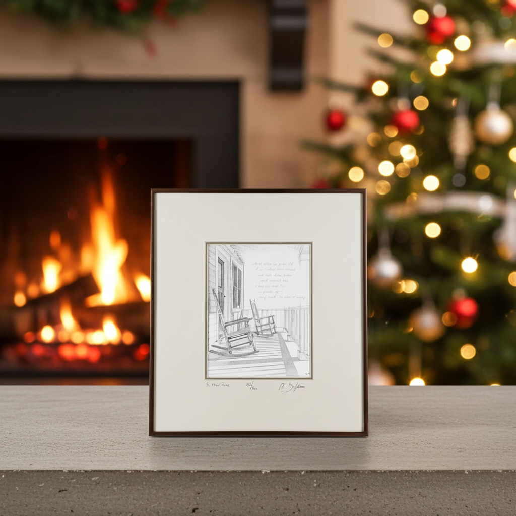 Framed black and white print of a porch scene with rocking chairs on a mantelpiece with a fireplace and Christmas tree in the background