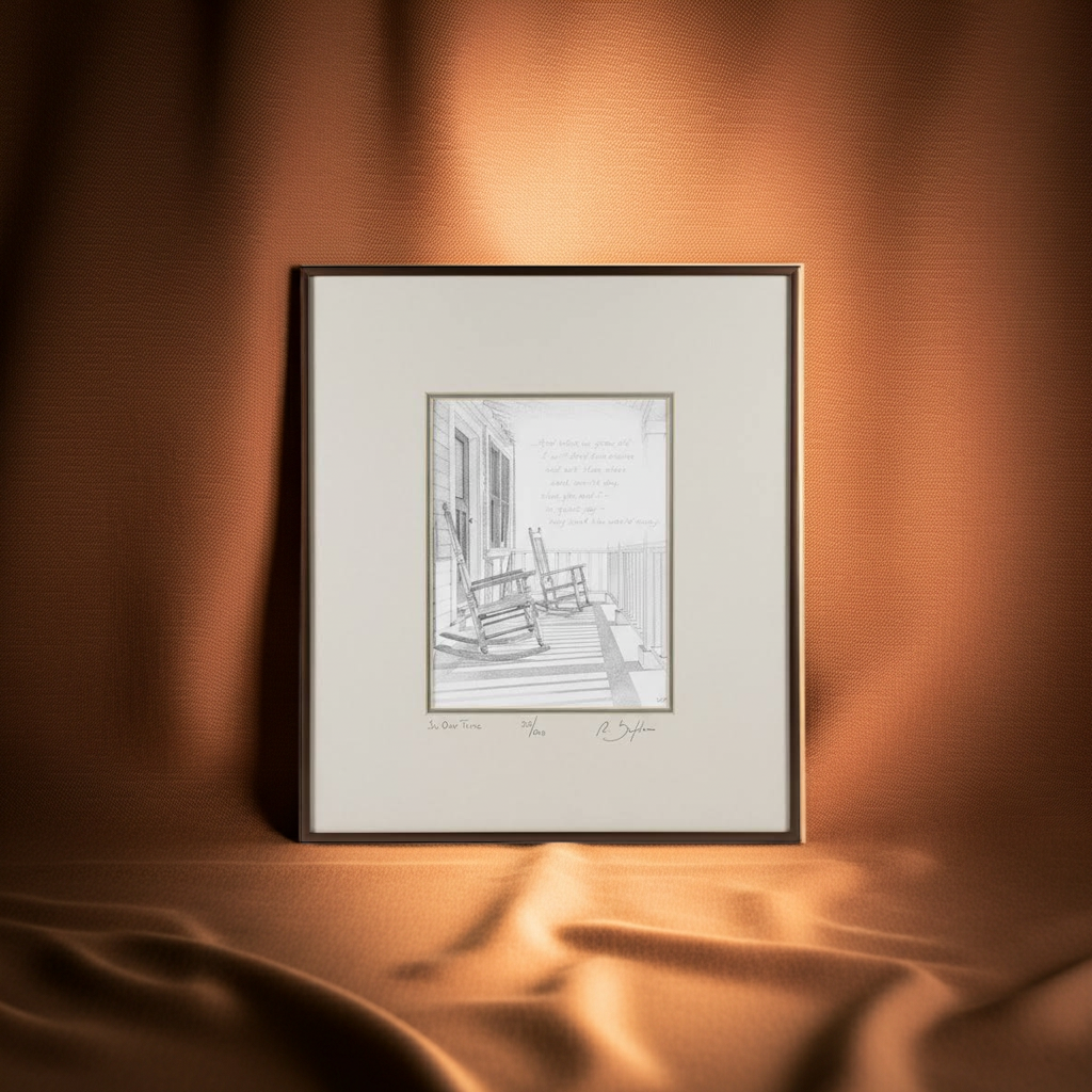 Framed black and white print of a porch scene with rocking chairs on a textured brown wall.