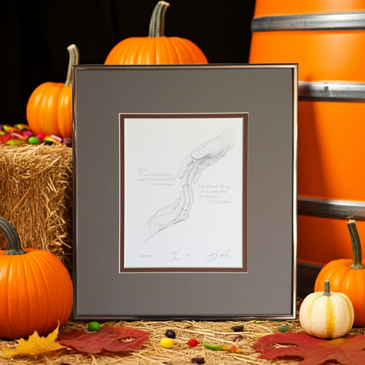 Framed artwork with pumpkins and hay bale on a dark background