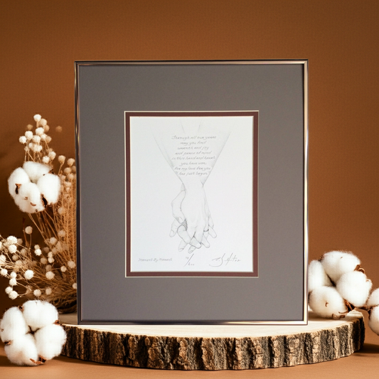 Framed artwork of holding hands on a wooden stand with cotton decorations