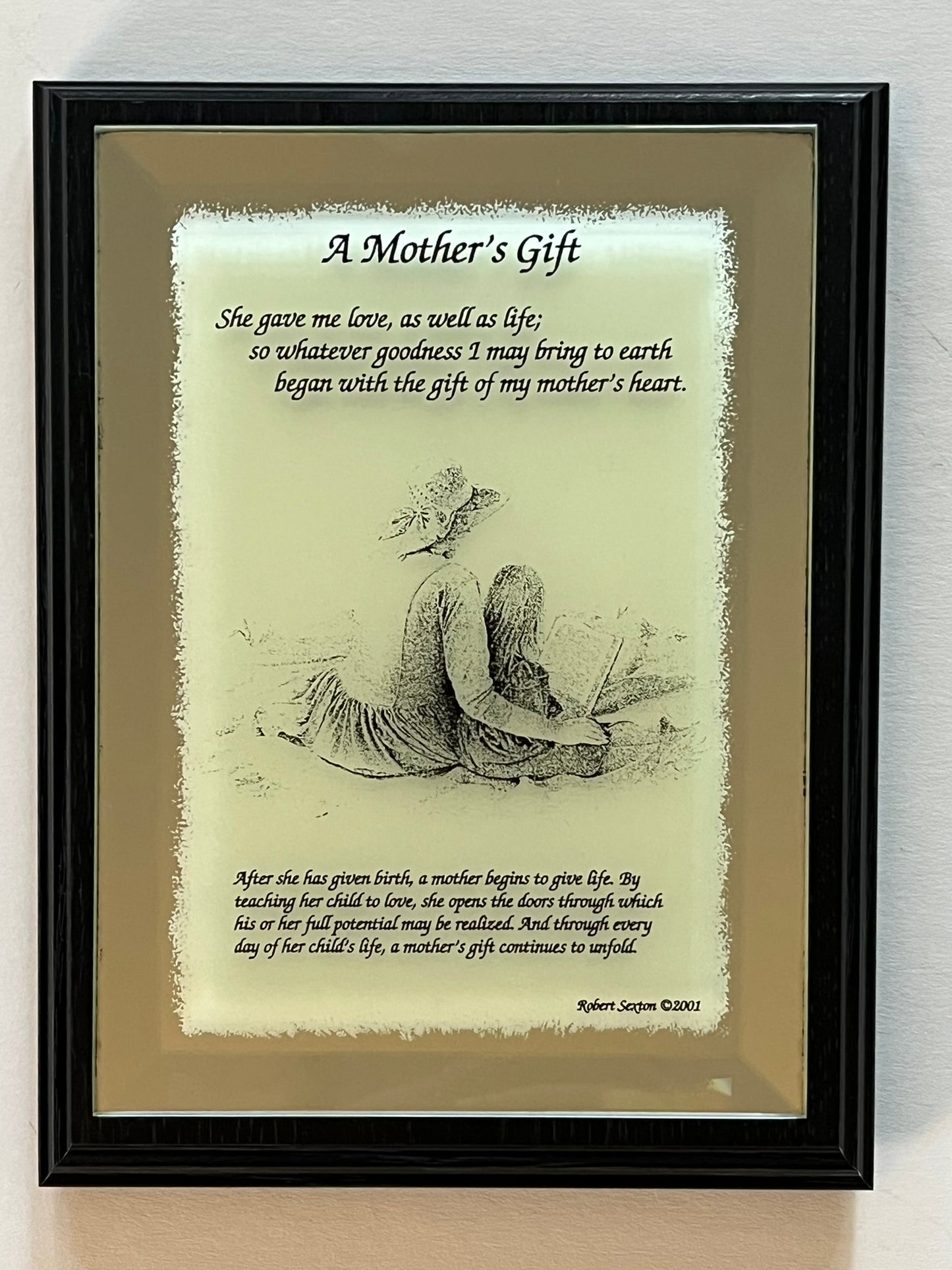 Framed print with a mother and child illustration and poem on a reflective surface