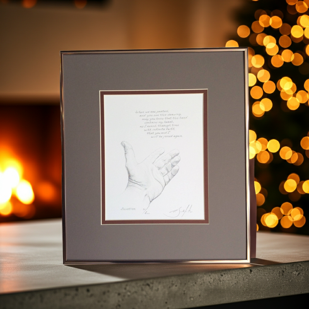Framed artwork of a handprint on a table with a warm, blurred background