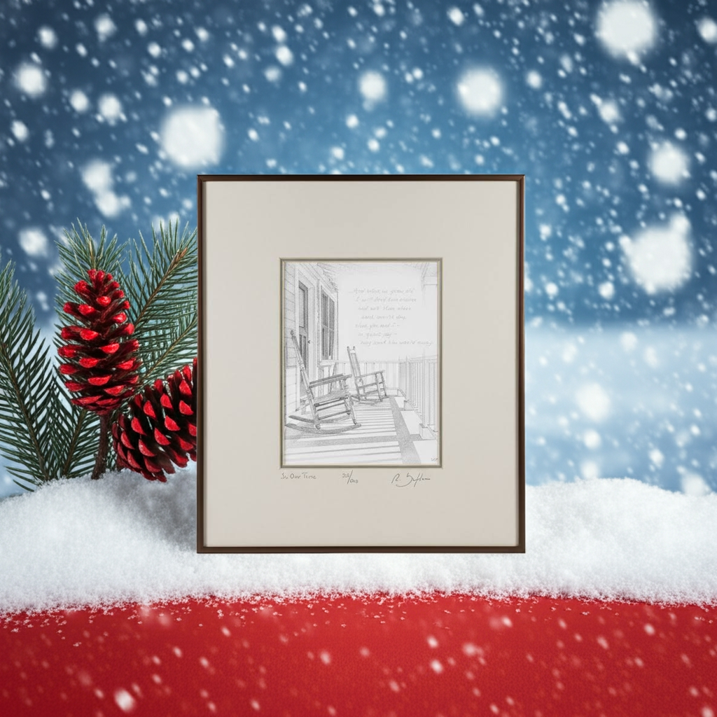 Framed black and white print of a porch scene with rocking chairs with red pinecones and greenery against a snowy background