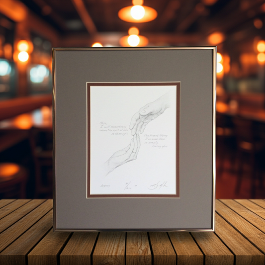 Framed artwork on a wooden table with a blurred bar background