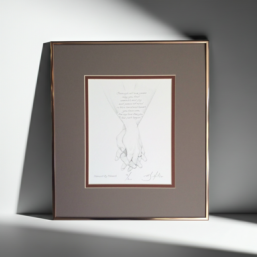 Framed artwork of holding hands  on a gray background