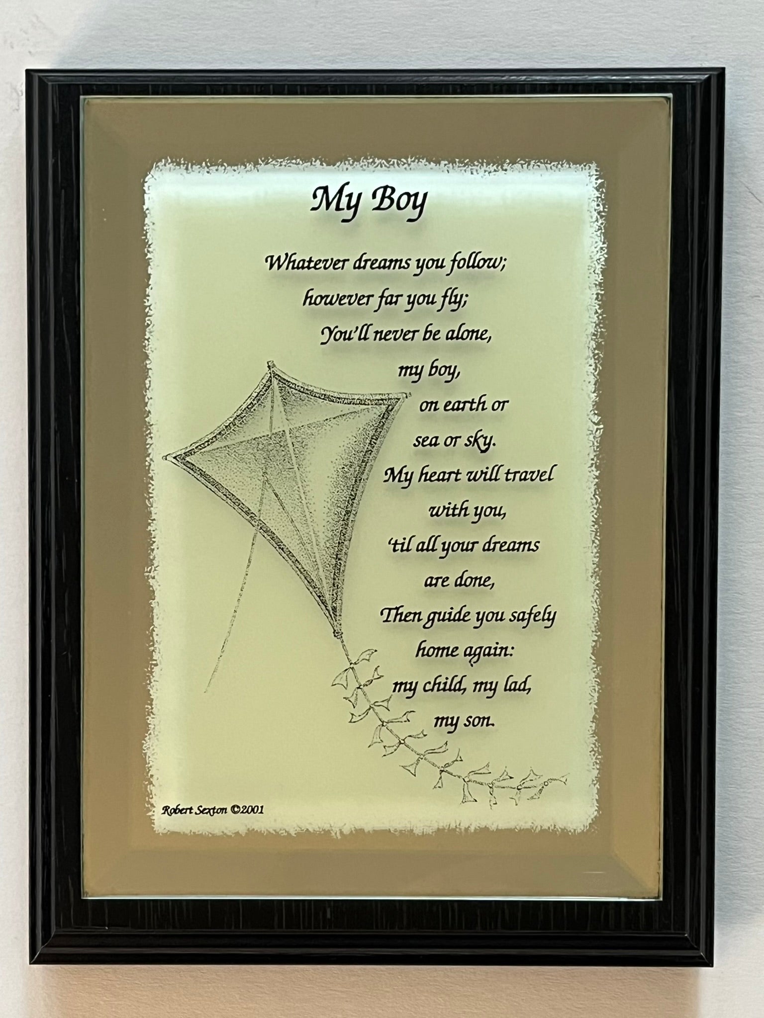 Framed artwork with a kite illustration and quote on a light background