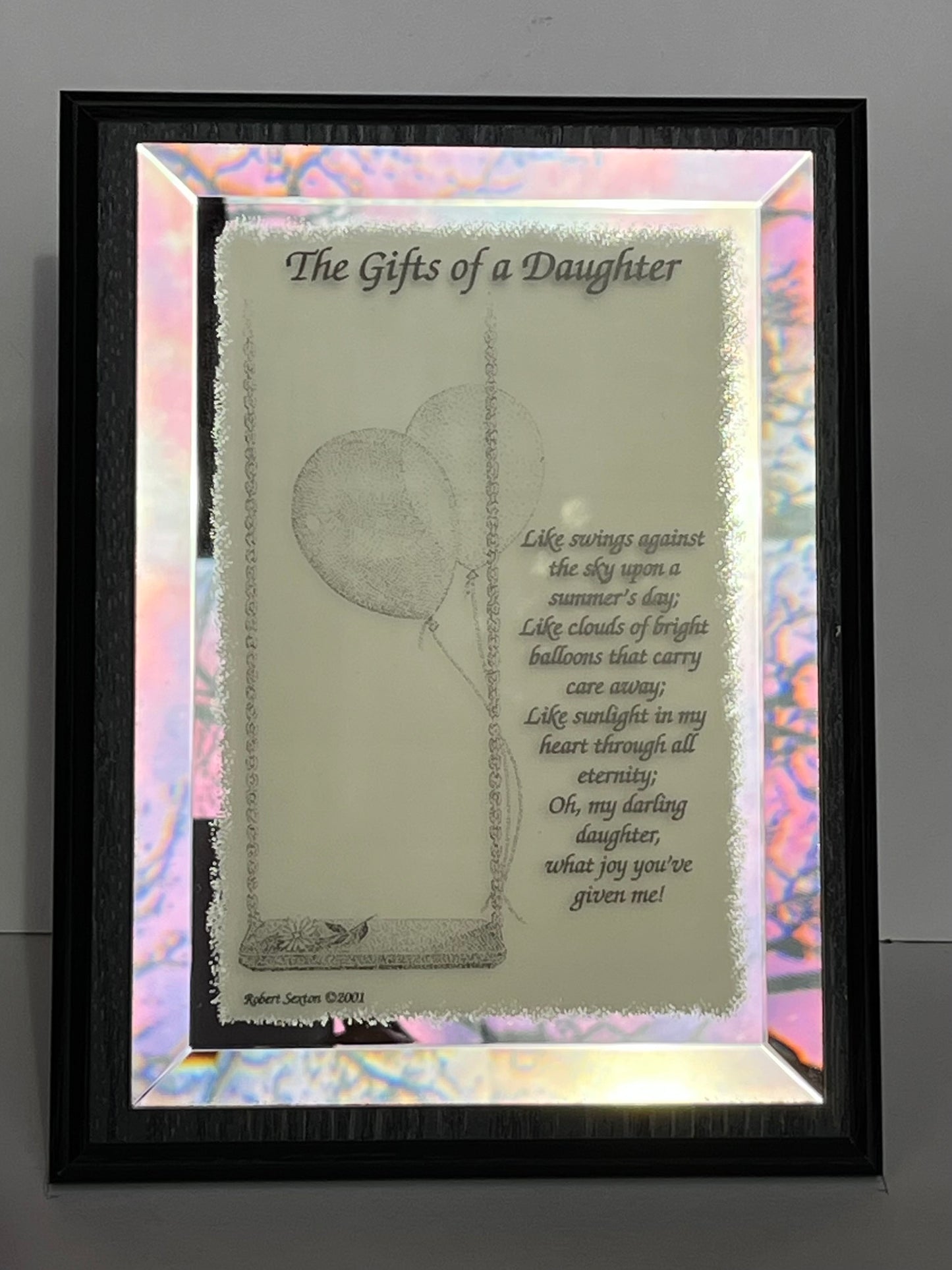 Decorative glass panel with a poem titled 'The Gifts of a Daughter' featuring a swing and balloons.