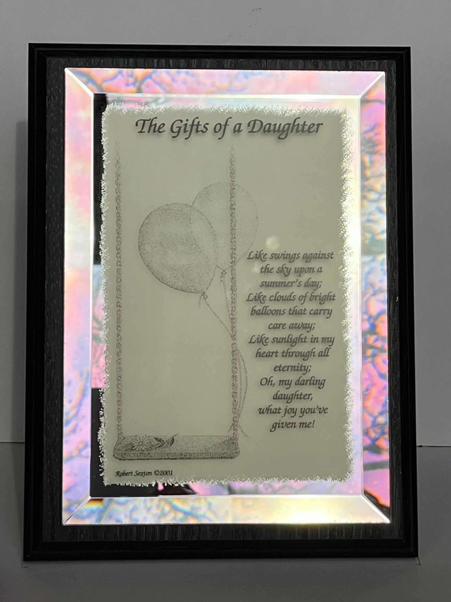 Decorative glass panel with a poem titled 'The Gifts of a Daughter' featuring a swing and balloons.