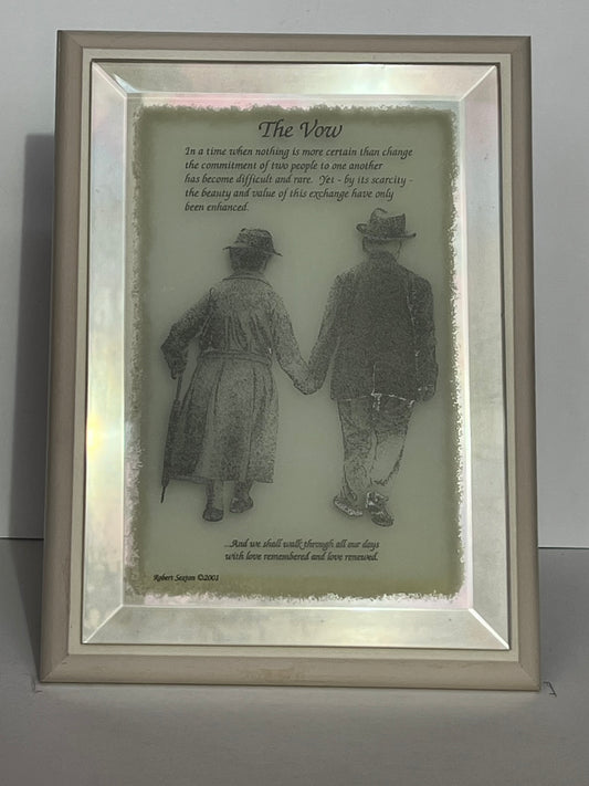 Framed artwork of two people holding hands with a poem titled 'The Vow' 