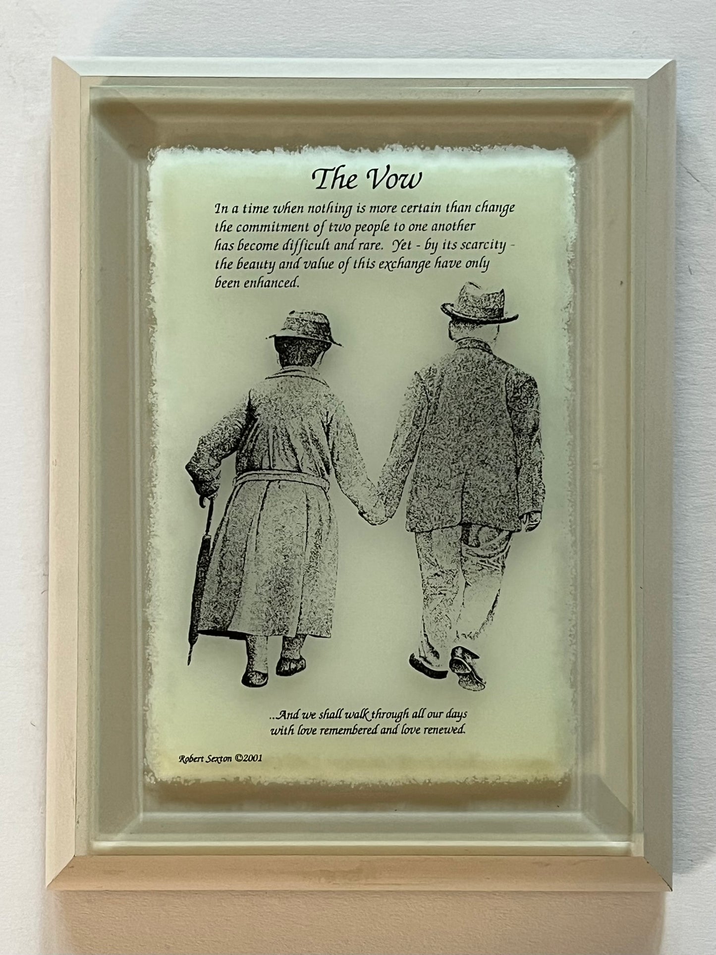 Framed artwork of two people holding hands with a poem titled 'The Vow' 