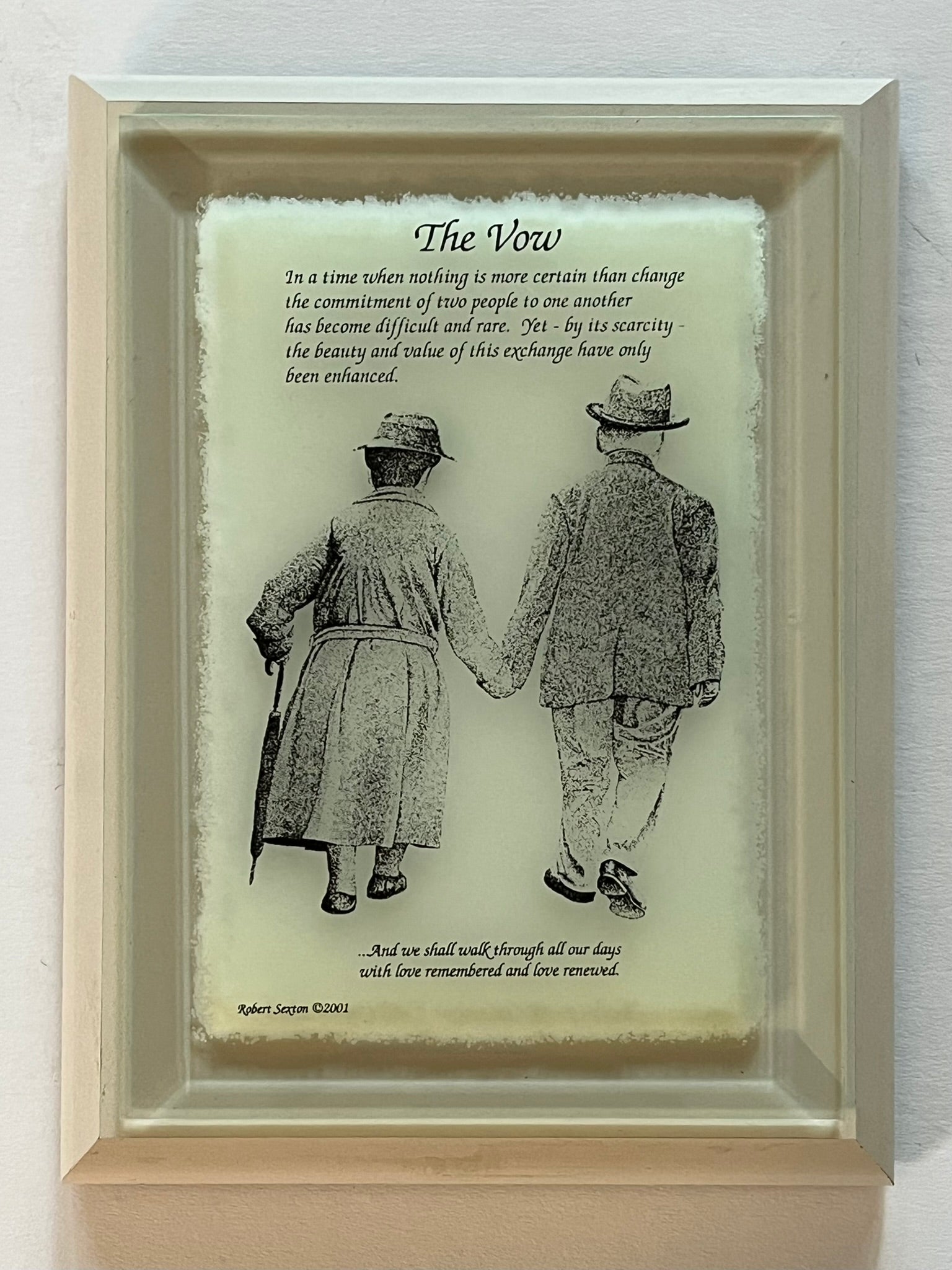 Framed artwork of two people holding hands with a poem titled 'The Vow' 