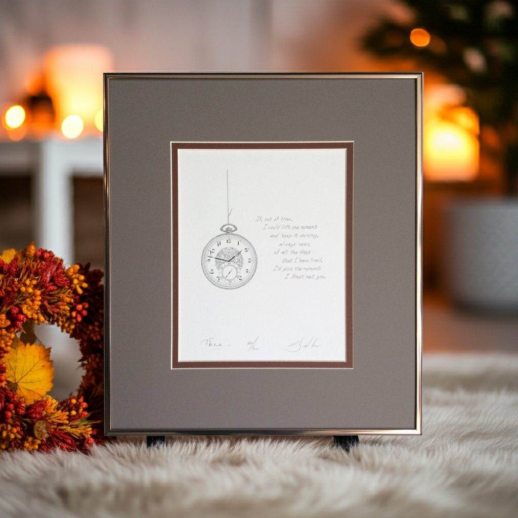 Framed artwork with a clock design on a soft surface with a blurred background
