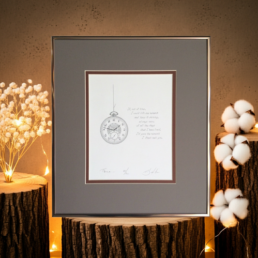 Framed artwork with a clock design on a decorative table with floral arrangements.