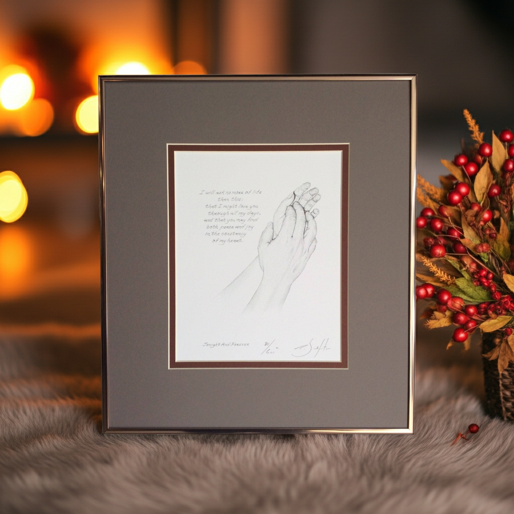 Framed artwork of two hands holding with a blurred festive background