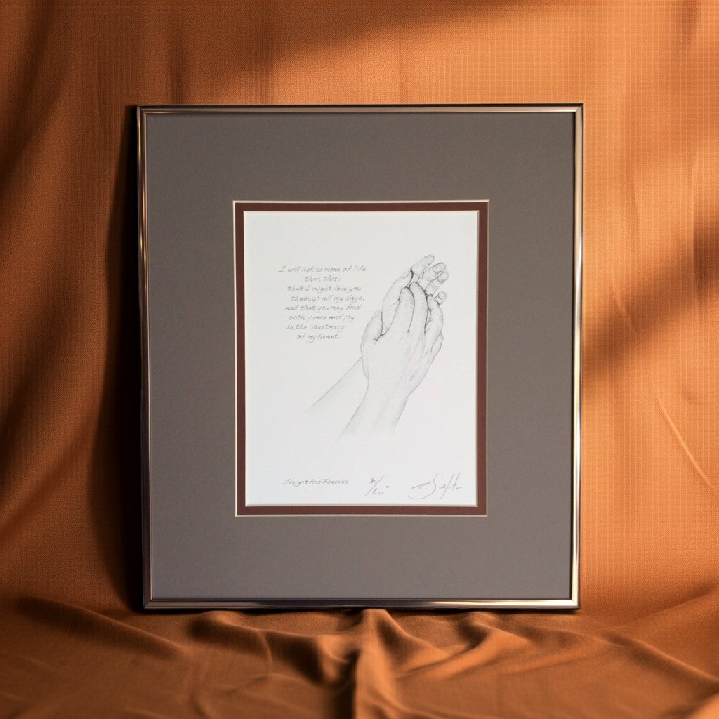 Framed artwork of holding hands on a brown fabric background